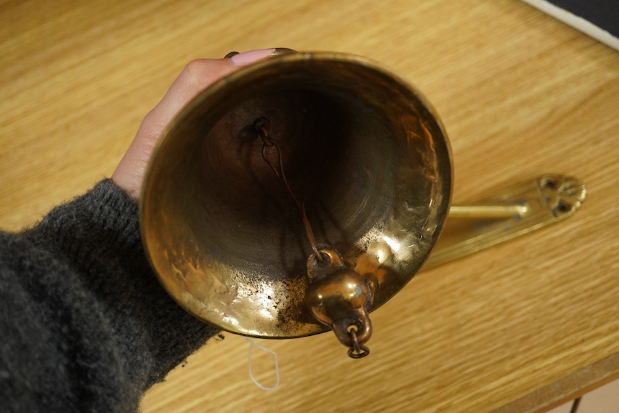 A brass bell with wall mount, 24cm high. Condition - good